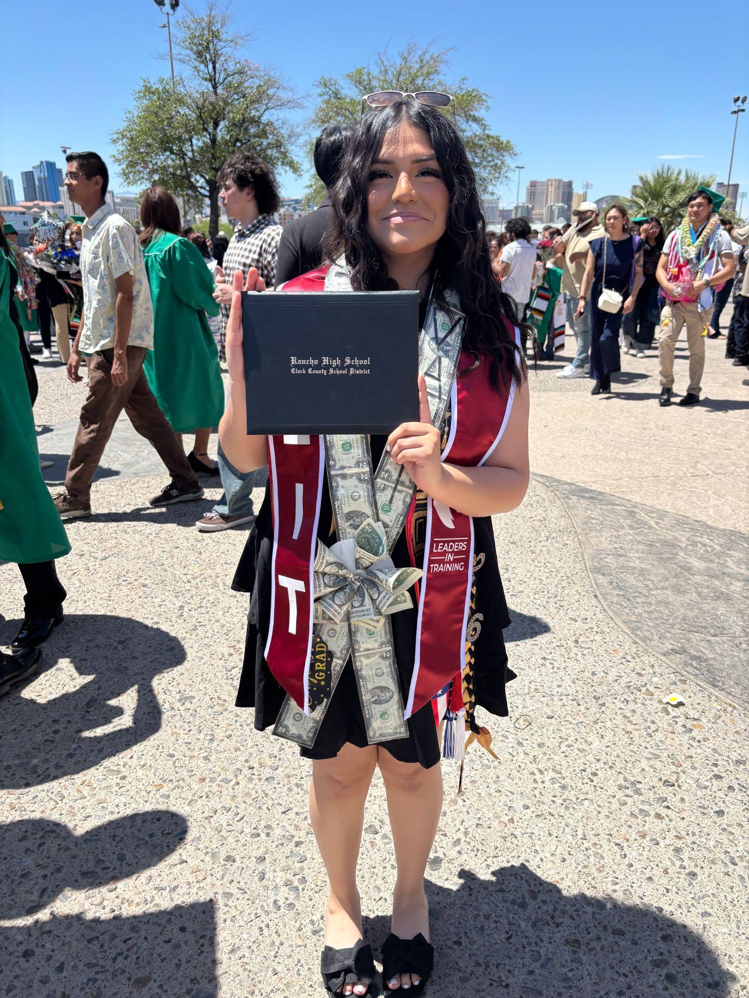 LIT graduate holding her Rancho High School diploma