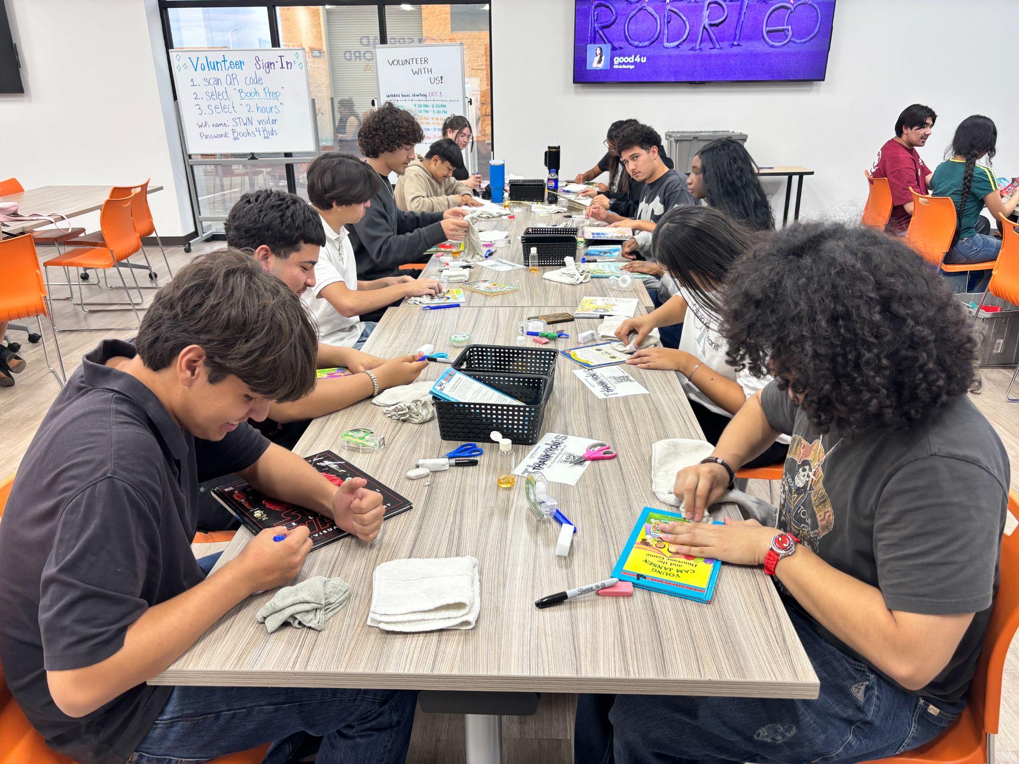 LIT students working together around a table during a volunteer session